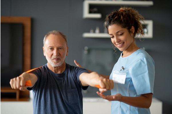 Rehabilitation worker guiding a patient through stretching routine